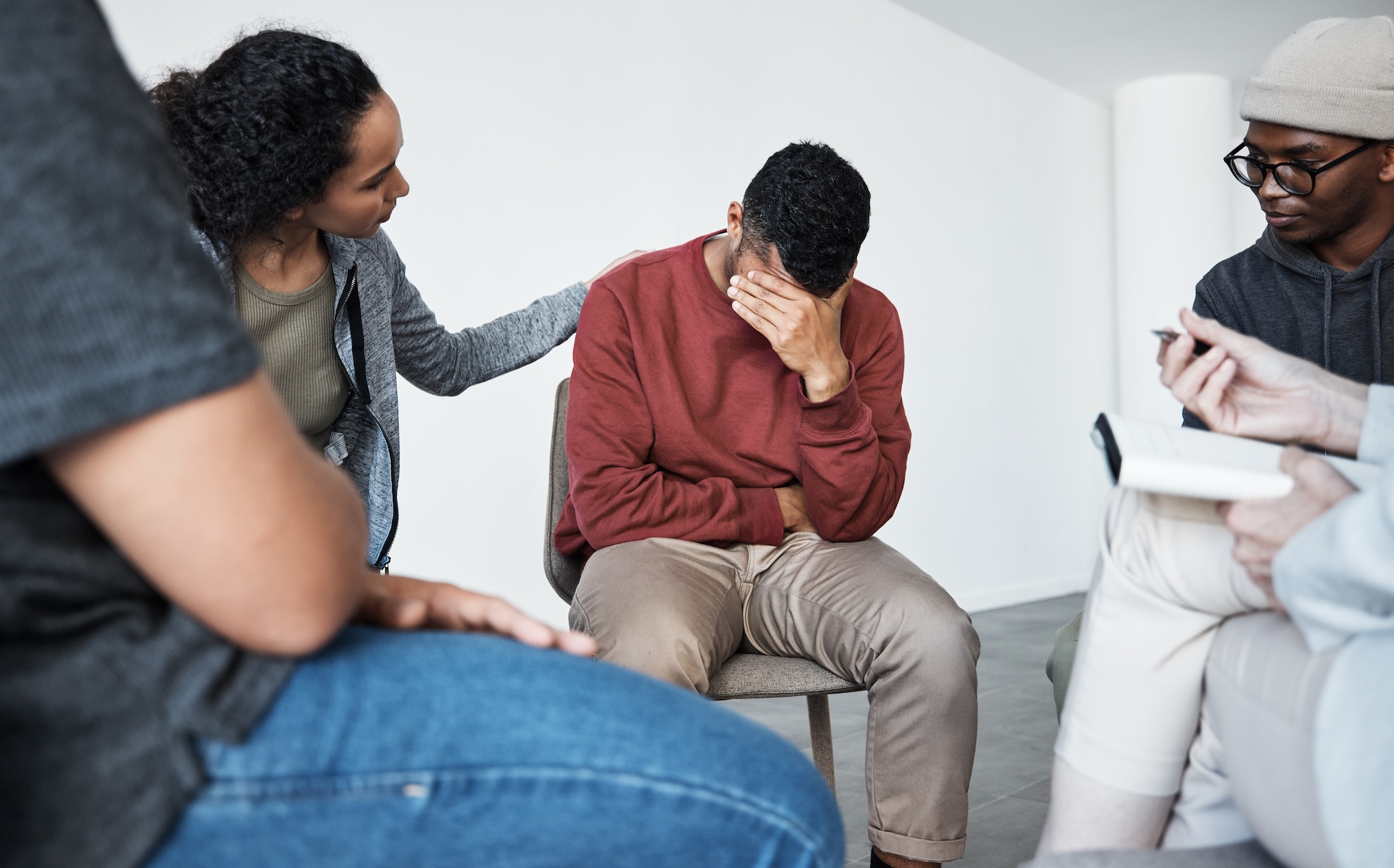 Man being supported during a therapy session