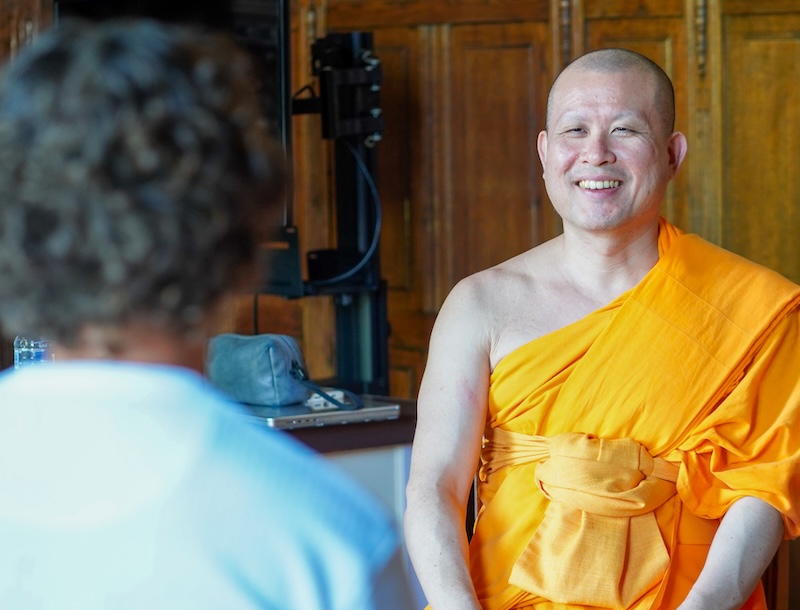 Monk smiling at participant