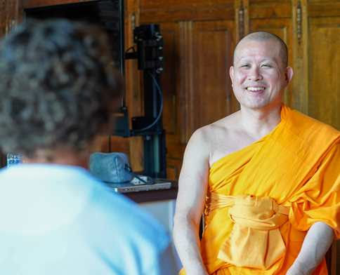 Monk smiling at participant